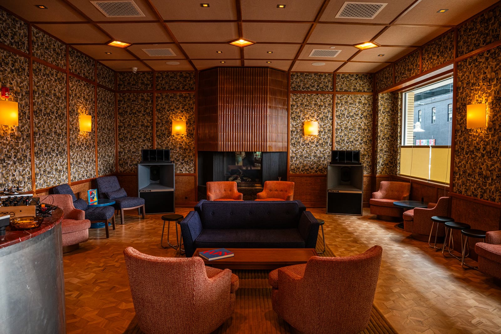 Percy's 70s-inspired sound lounge with orange armchairs, parquet floors, and Altec Lansing speakers